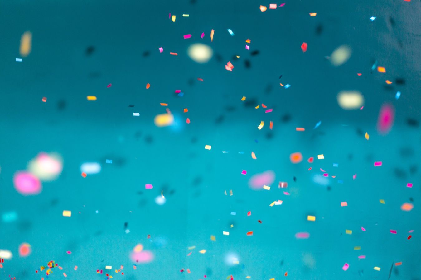 turquoise background with confetti